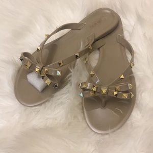 Studded jelly flip flop sandals.